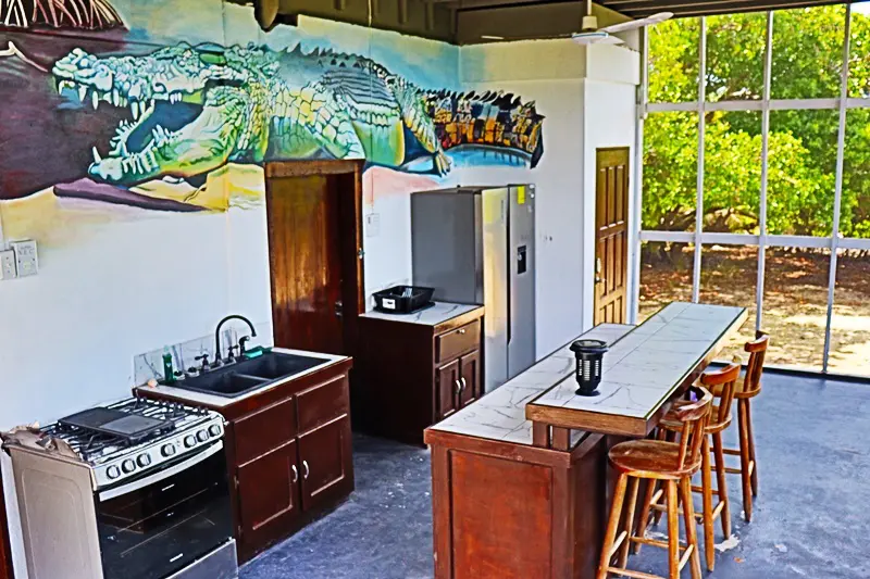 A kitchen with a bar and stools in it