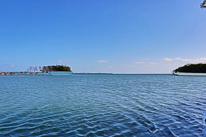 A view of the ocean with a small island in the distance.