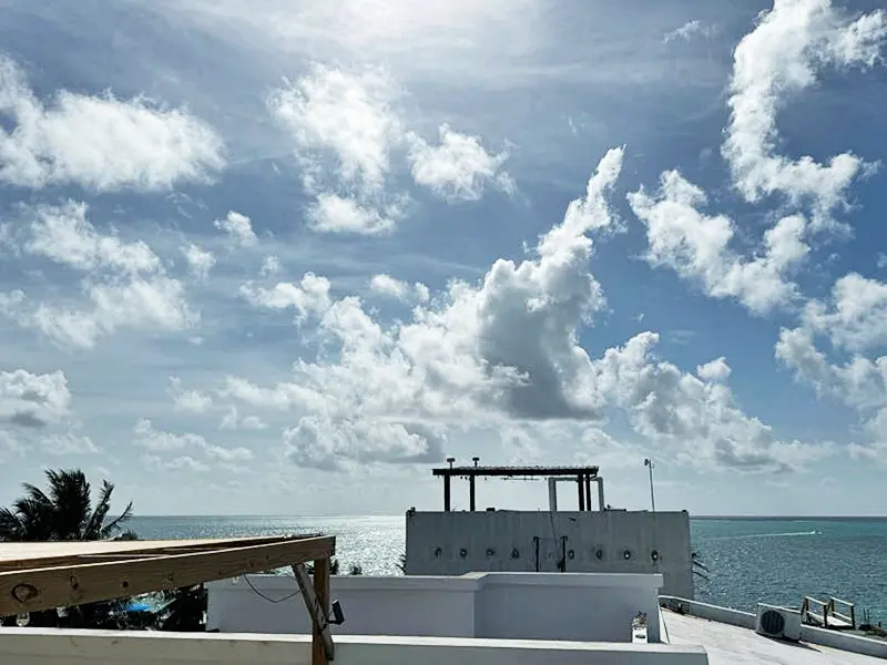 A boat is docked on the beach under clouds.