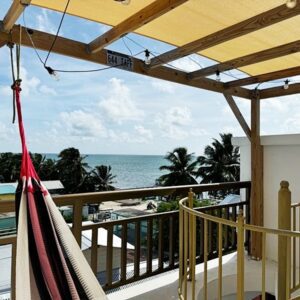 A hammock hanging from the side of a balcony.