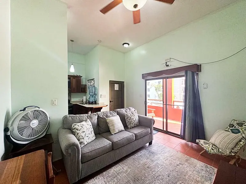 A living room with a couch and a fan