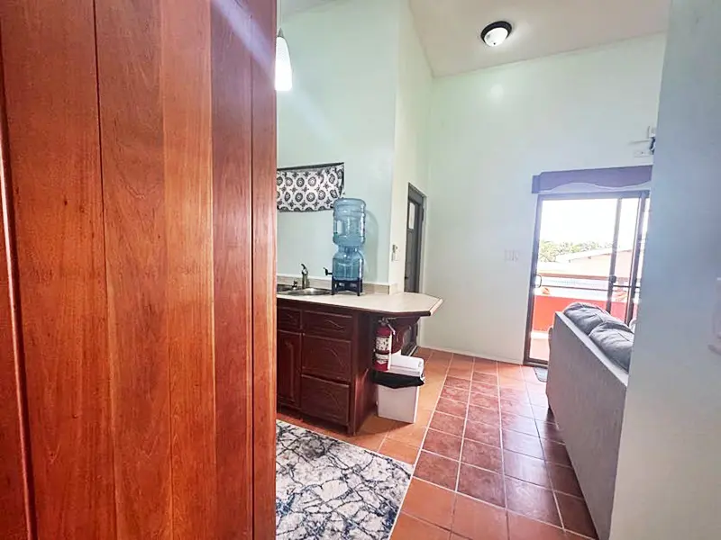 A bathroom with a sink, toilet and mirror.