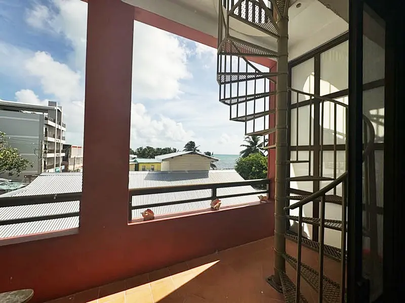 A view of the ocean from inside a building.