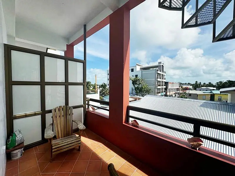 A balcony with a view of the ocean and a sky background