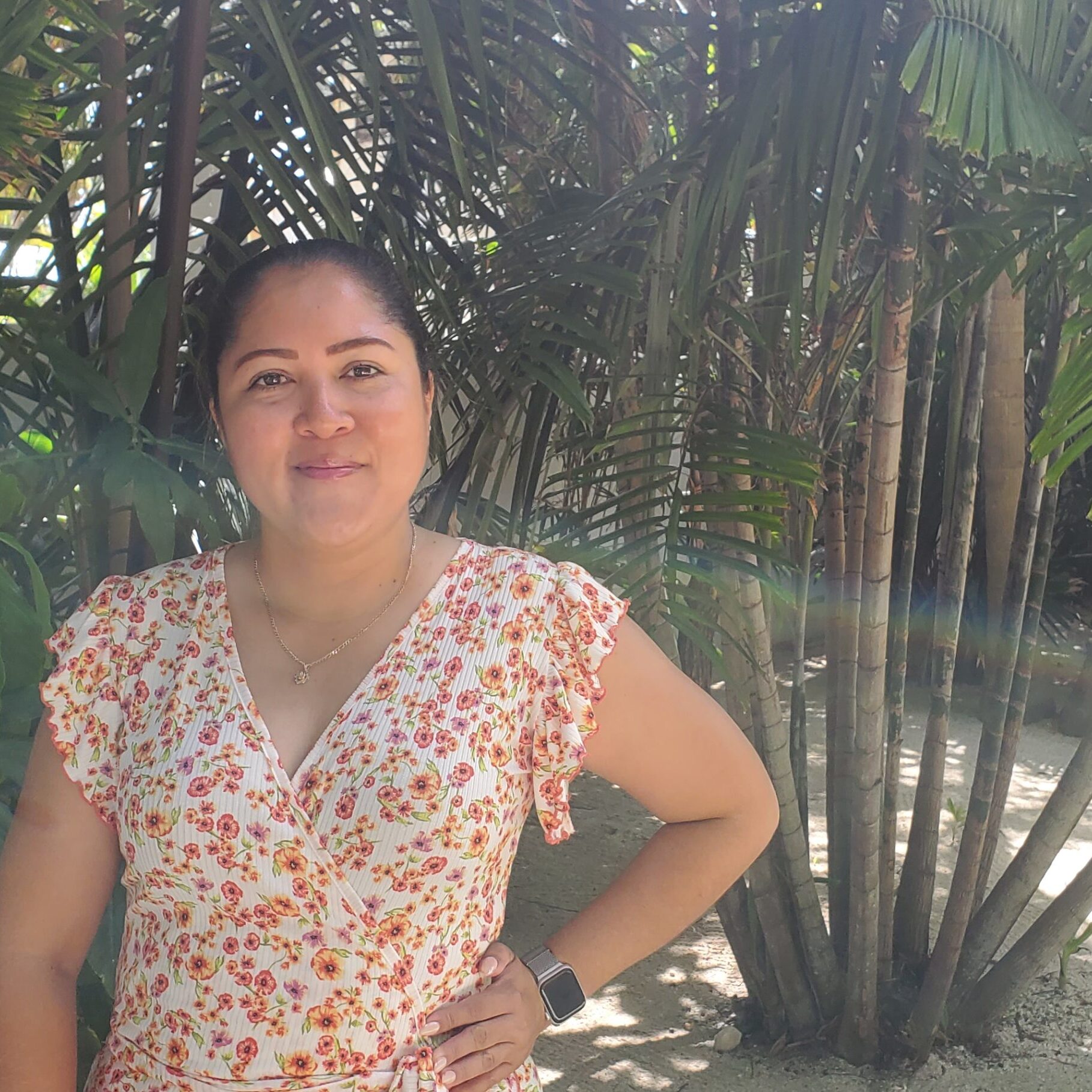 A woman standing in front of some trees