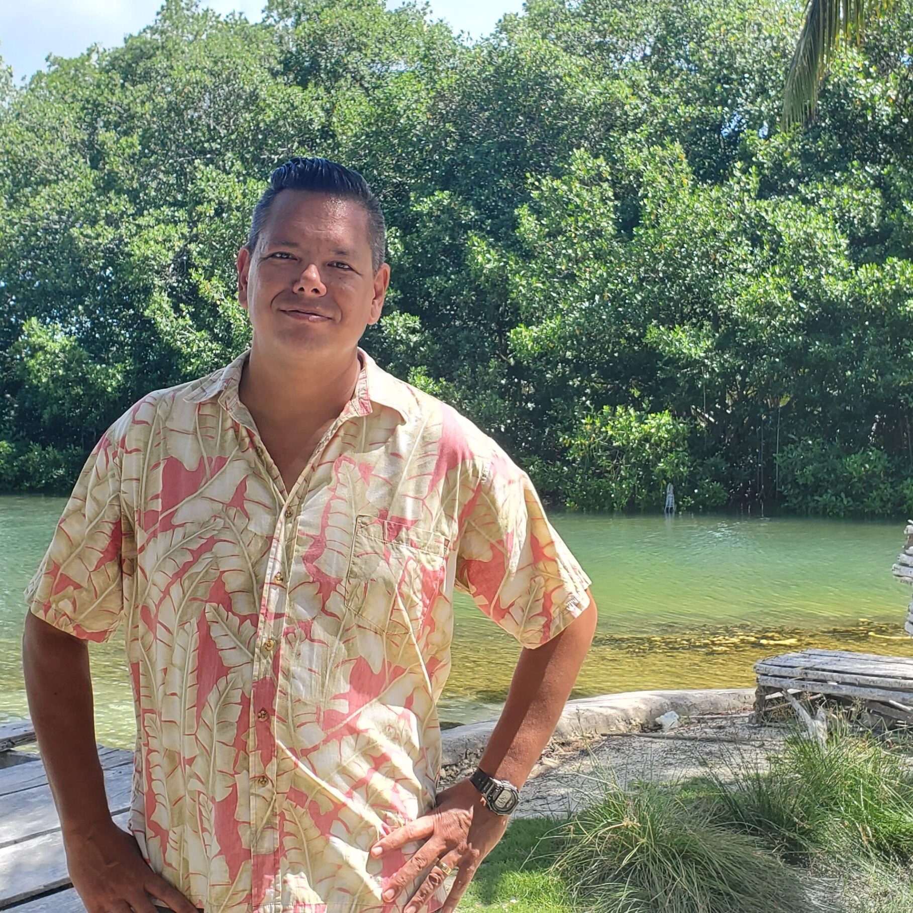 A man standing in front of some trees